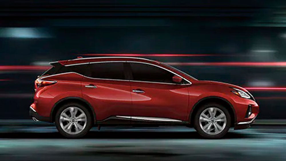2023 Nissan Murano shown in profile driving down a street at night illustrating performance. | Vann York's High Point Nissan in High Point NC